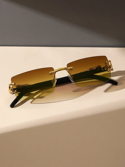 Gold-framed sunglasses with gold lenses on a light surface