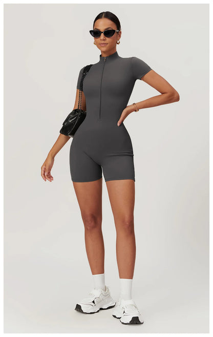 Woman wearing a gray bodysuit with black sleeves on a white background