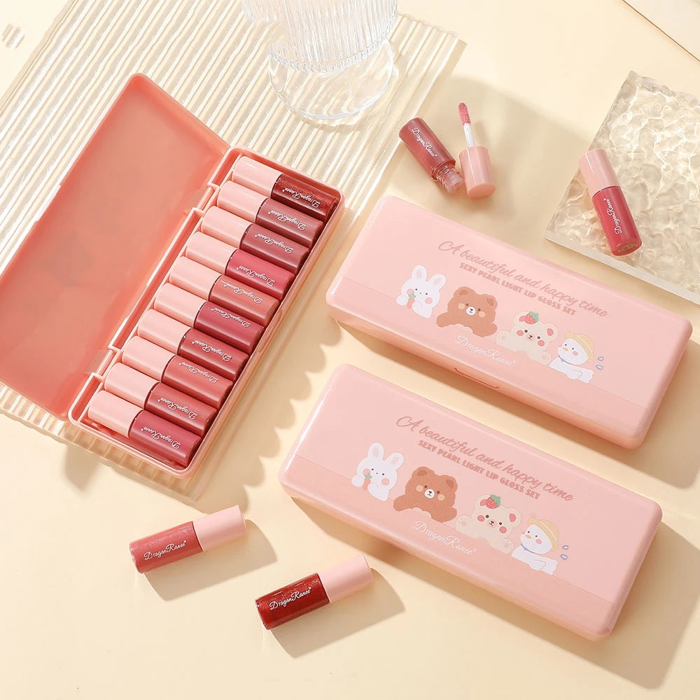 Set of pink lipsticks with cute packaging on a light background