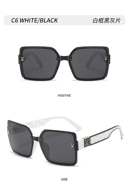 Black sunglasses with gold accents on a white background