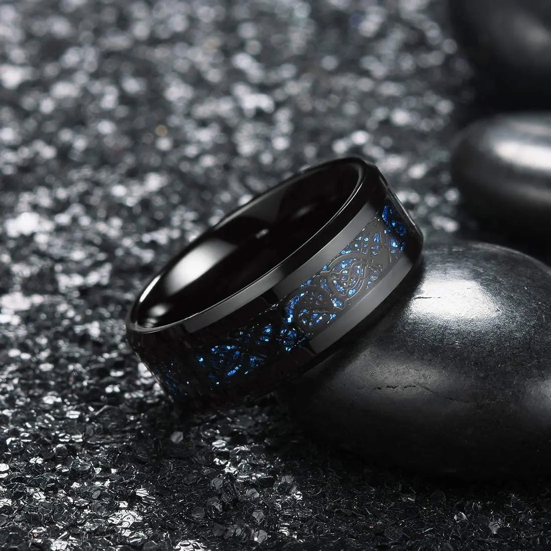 Black ring with blue interior design on a dark textured surface