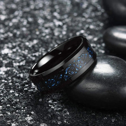 Black ring with blue interior design on a dark textured surface