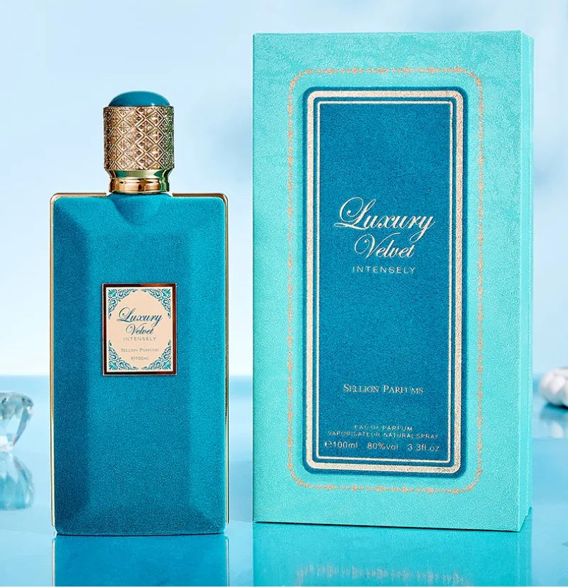 Luxury Velvet perfume bottle and packaging on a light blue background