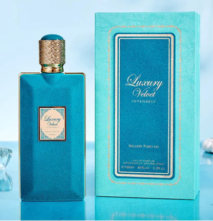 Luxury Velvet perfume bottle and packaging on a light blue background