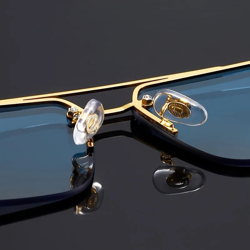 Gold-framed eyeglasses with clear lenses on a reflective black surface