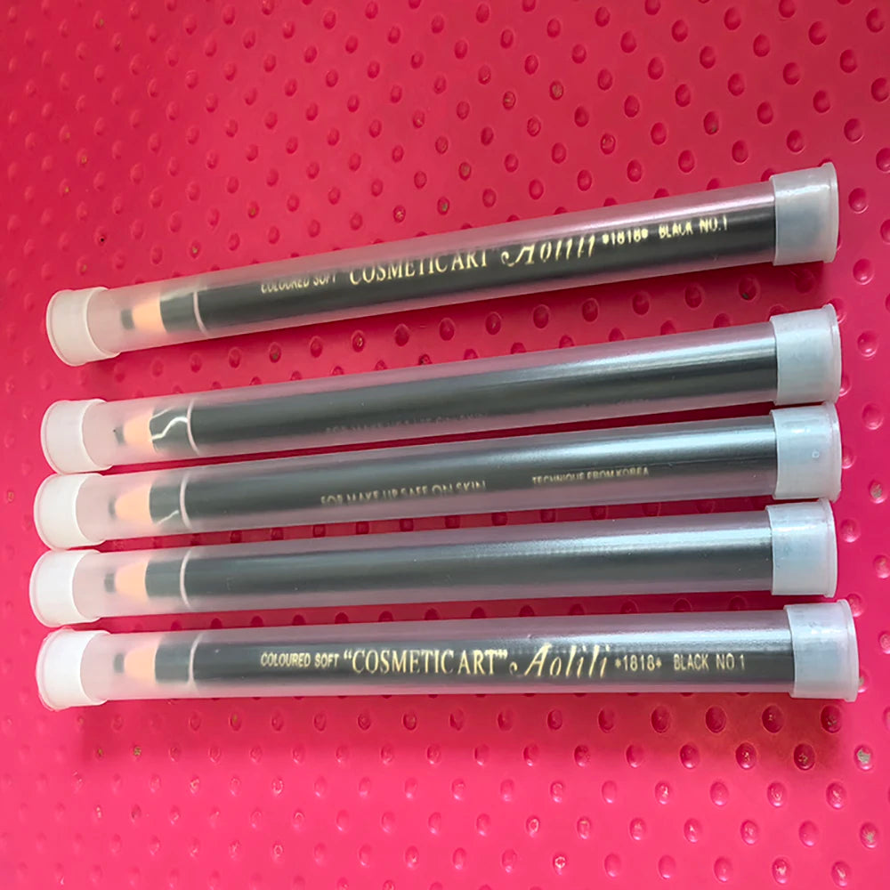 Set of cosmetic art pencils on a pink pegboard background