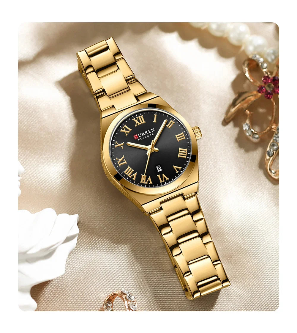 Gold wristwatch with black dial on a soft beige background