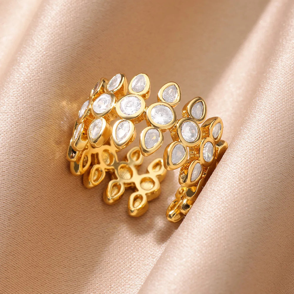 Gold ring with embedded stones on a beige fabric background