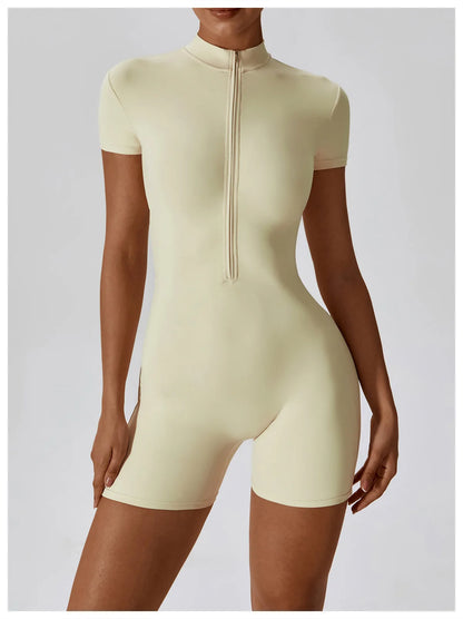 Beige bodysuit worn by a model on a plain background