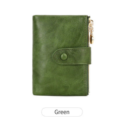 Green leather wallet with a gold zipper on a white background