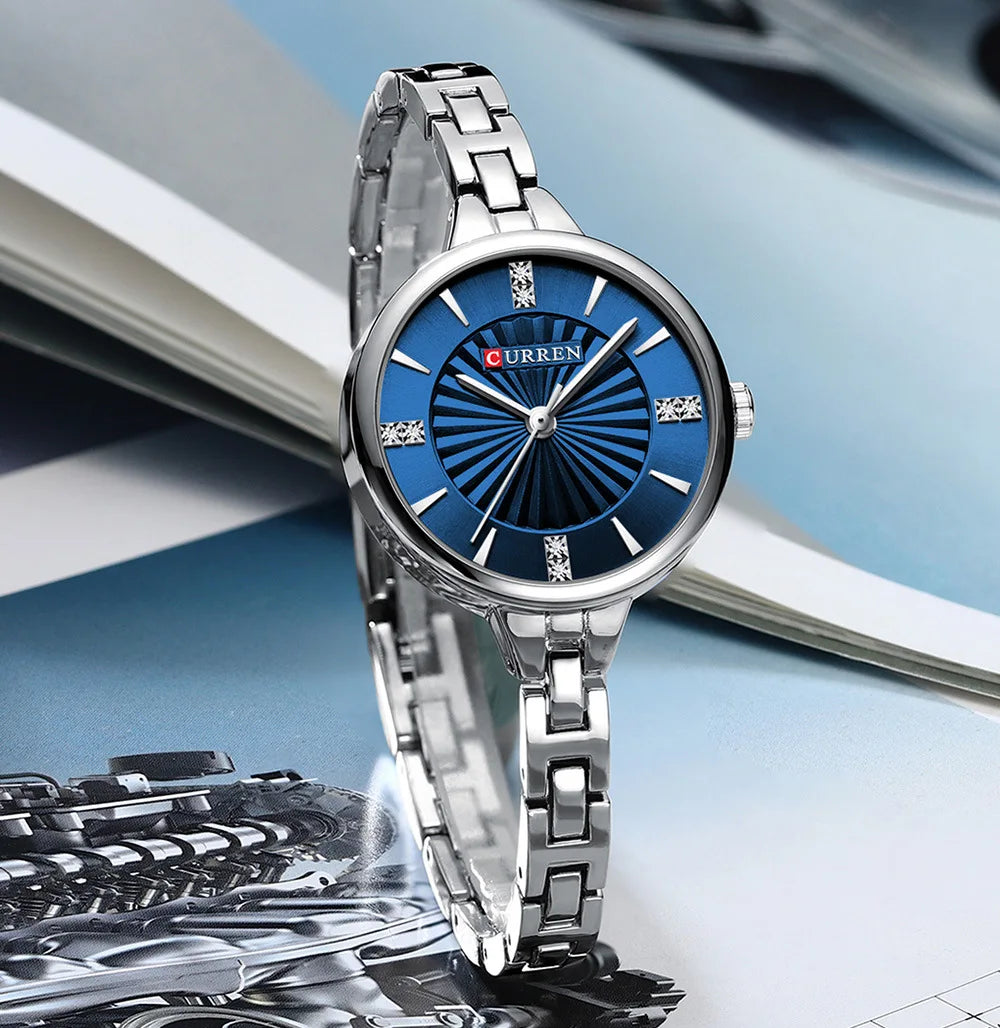 Silver watch with blue dial on a blurred background