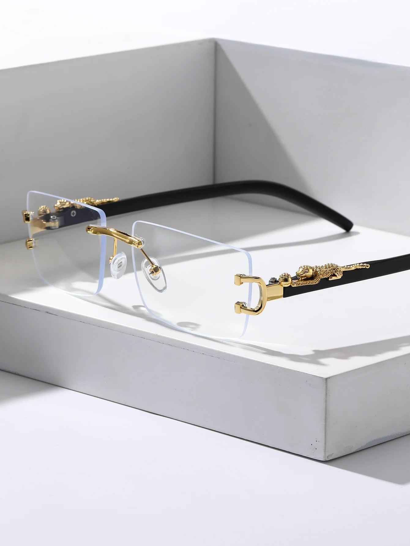 Eyeglasses with gold and black frame on a white background