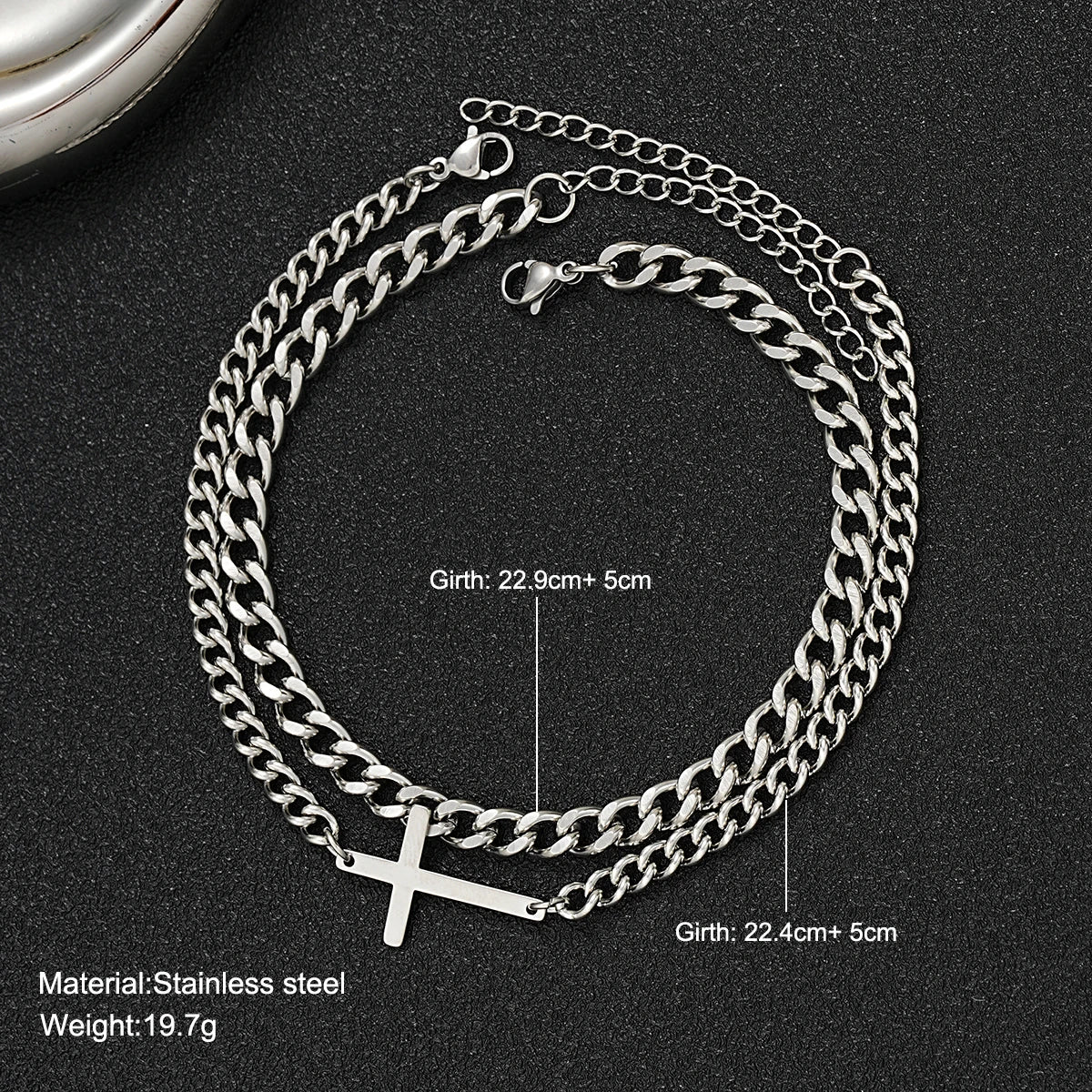 Silver chain necklace with cross pendant on a black background