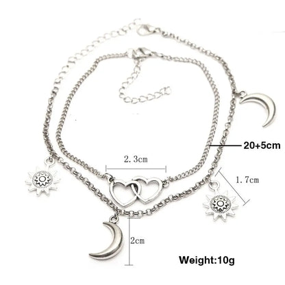 Silver anklet with charms and measurements on a white background