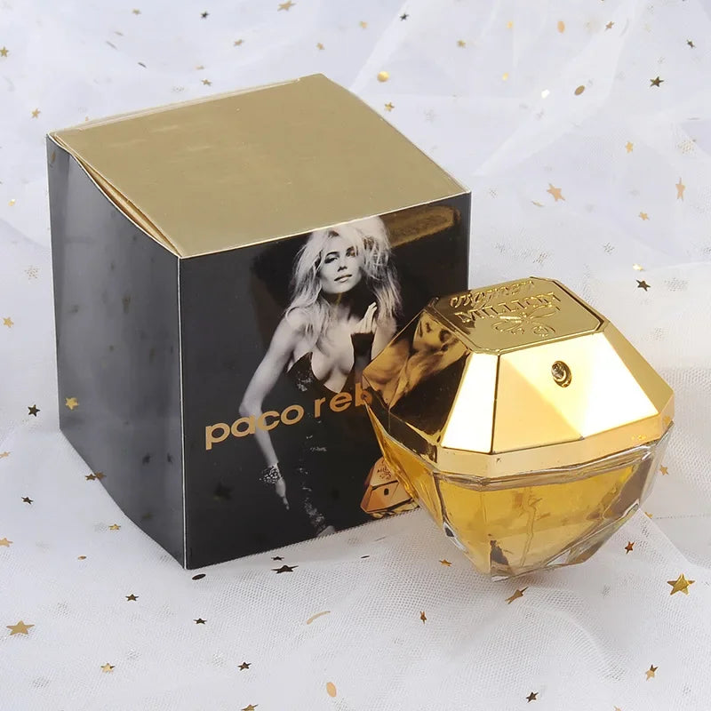 Gold perfume bottle and packaging with a starry background