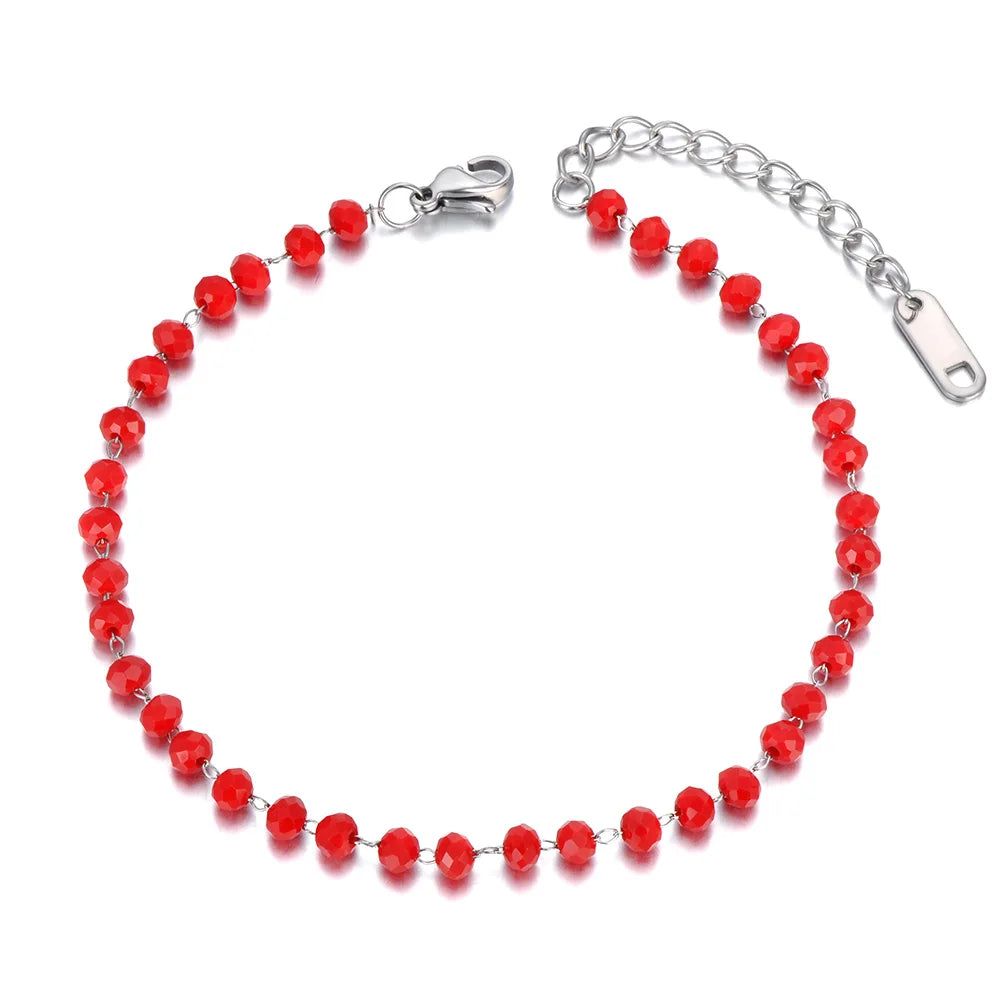 Red beaded bracelet with silver clasp on a white background