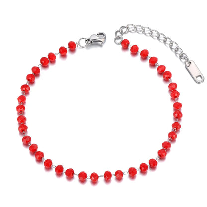 Red beaded bracelet with silver clasp on a white background