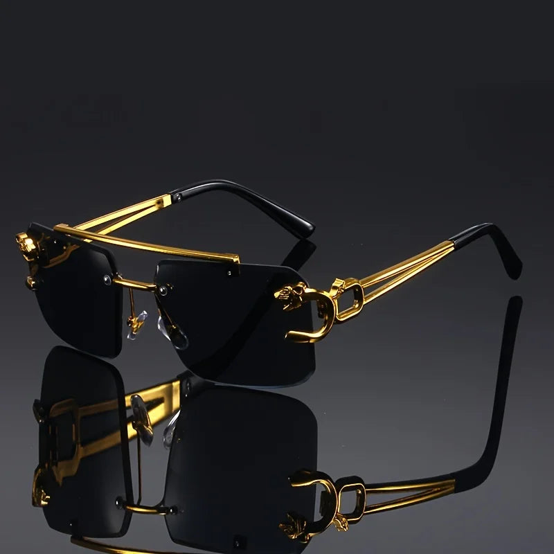 Gold-framed sunglasses with black lenses on a reflective surface.