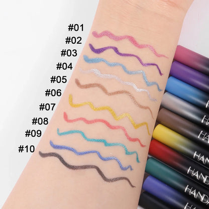 Colorful makeup pencils swatched on a wrist with labeled colors.