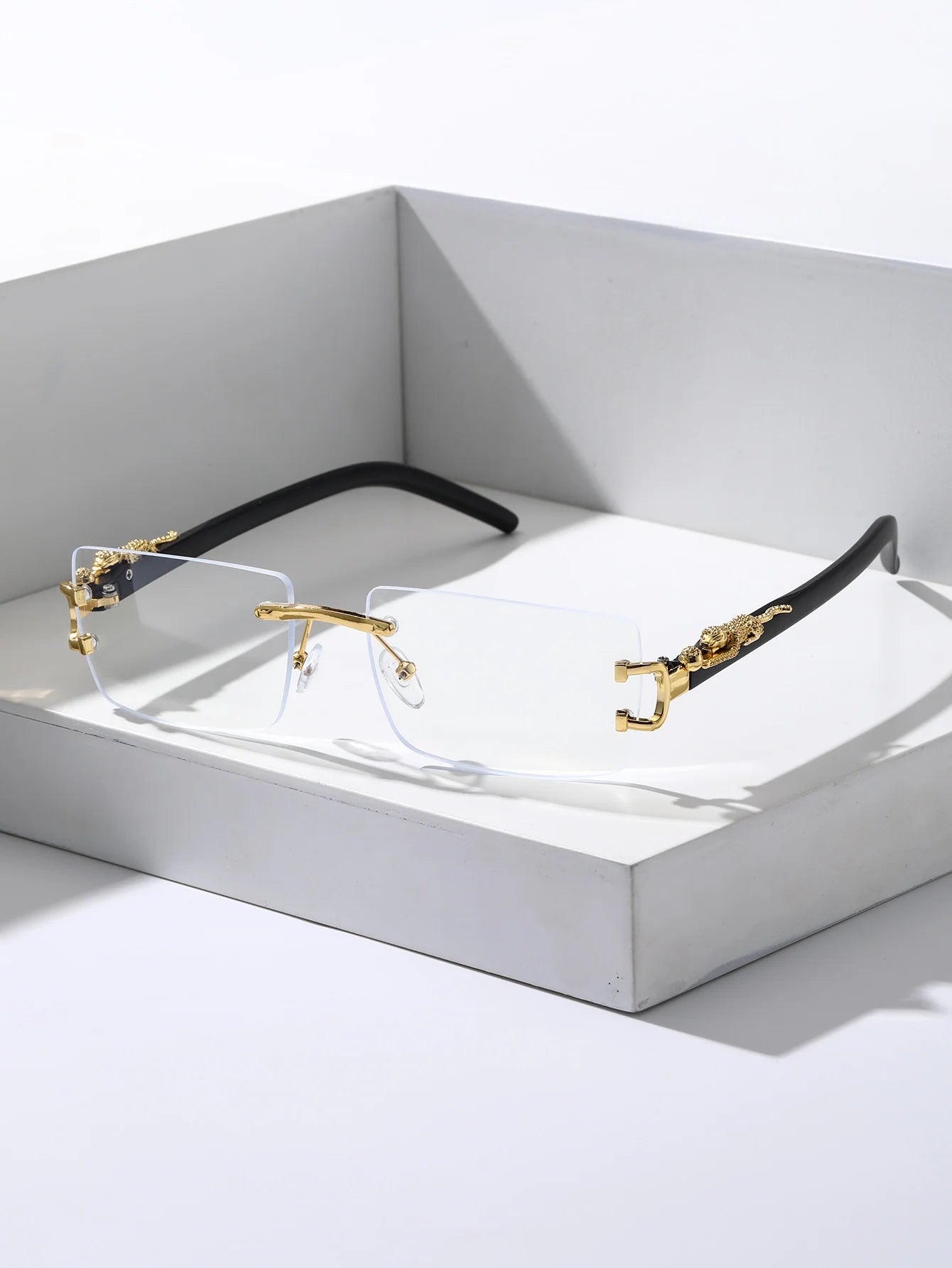 Eyeglasses with gold and black frame on a white background