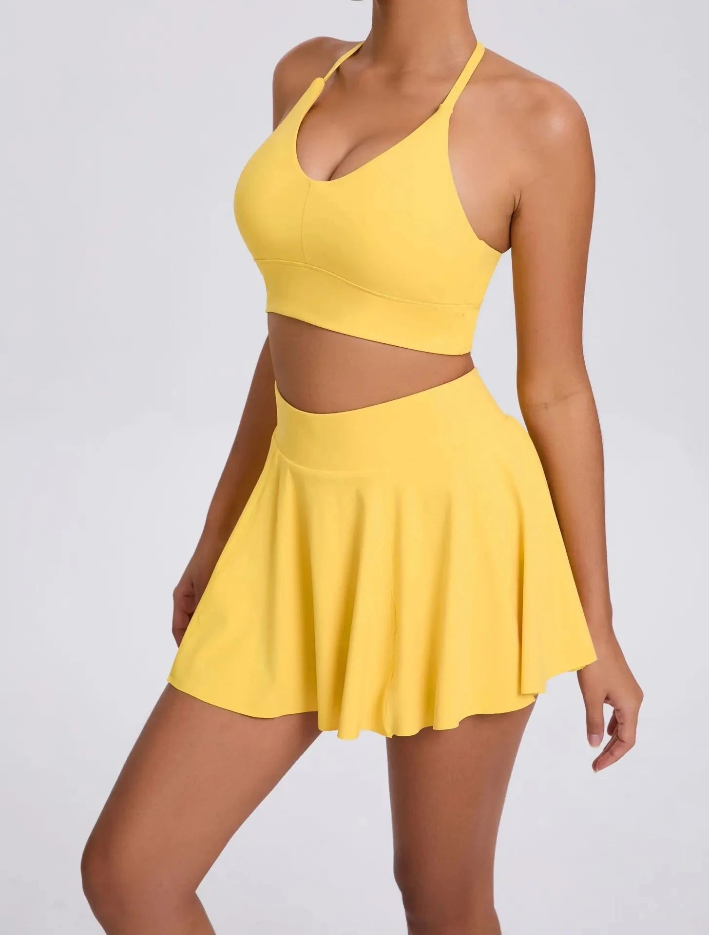 Yellow two-piece outfit on a plain background