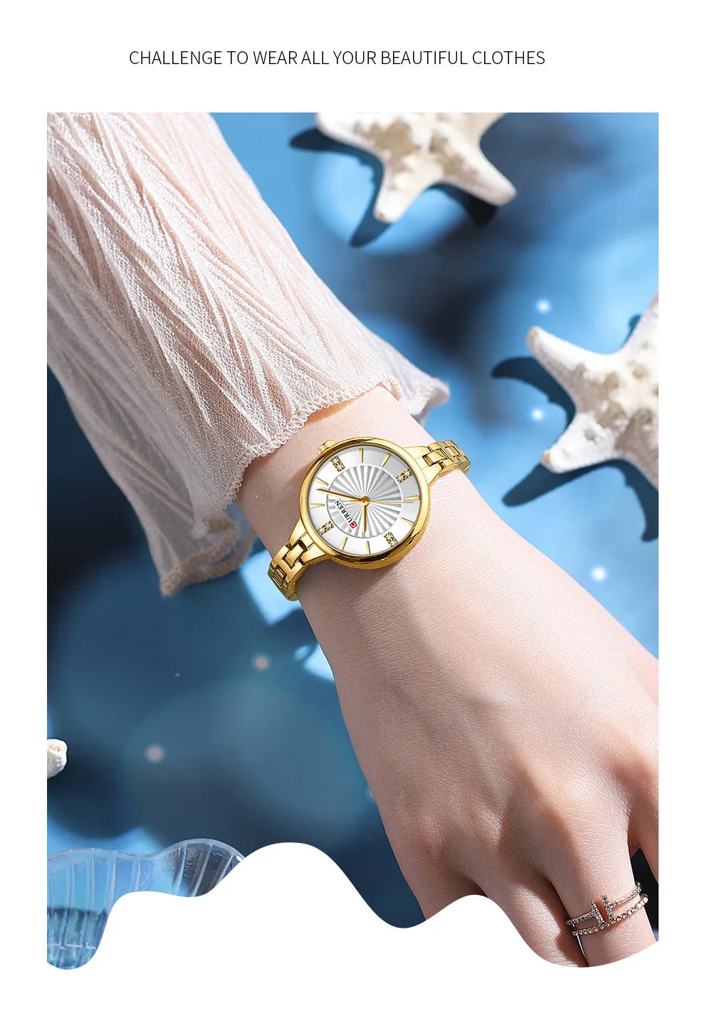 Gold wristwatch on a hand with a blue and white starfish background
