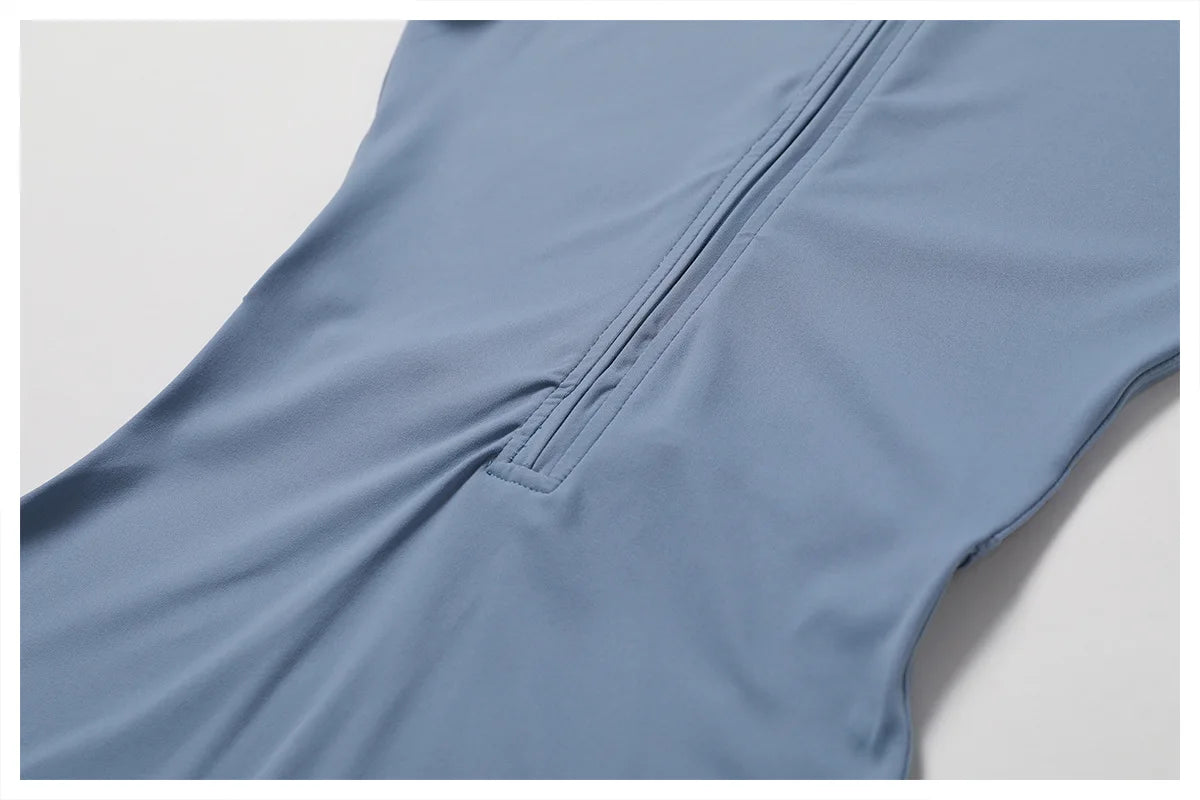 Close-up of a blue sleeveless garment with a zipper on a light gray background