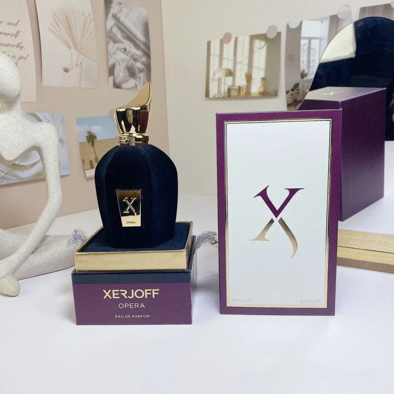 Xerjoff Opera perfume bottle and packaging on a white surface with decorative elements.