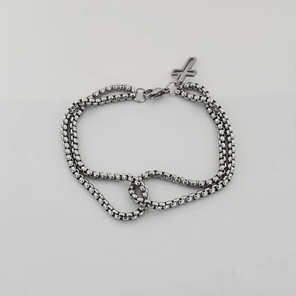 Silver chain bracelet on a light gray background