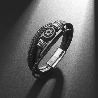 Black braided leather bracelet with metal accents on a dark surface
