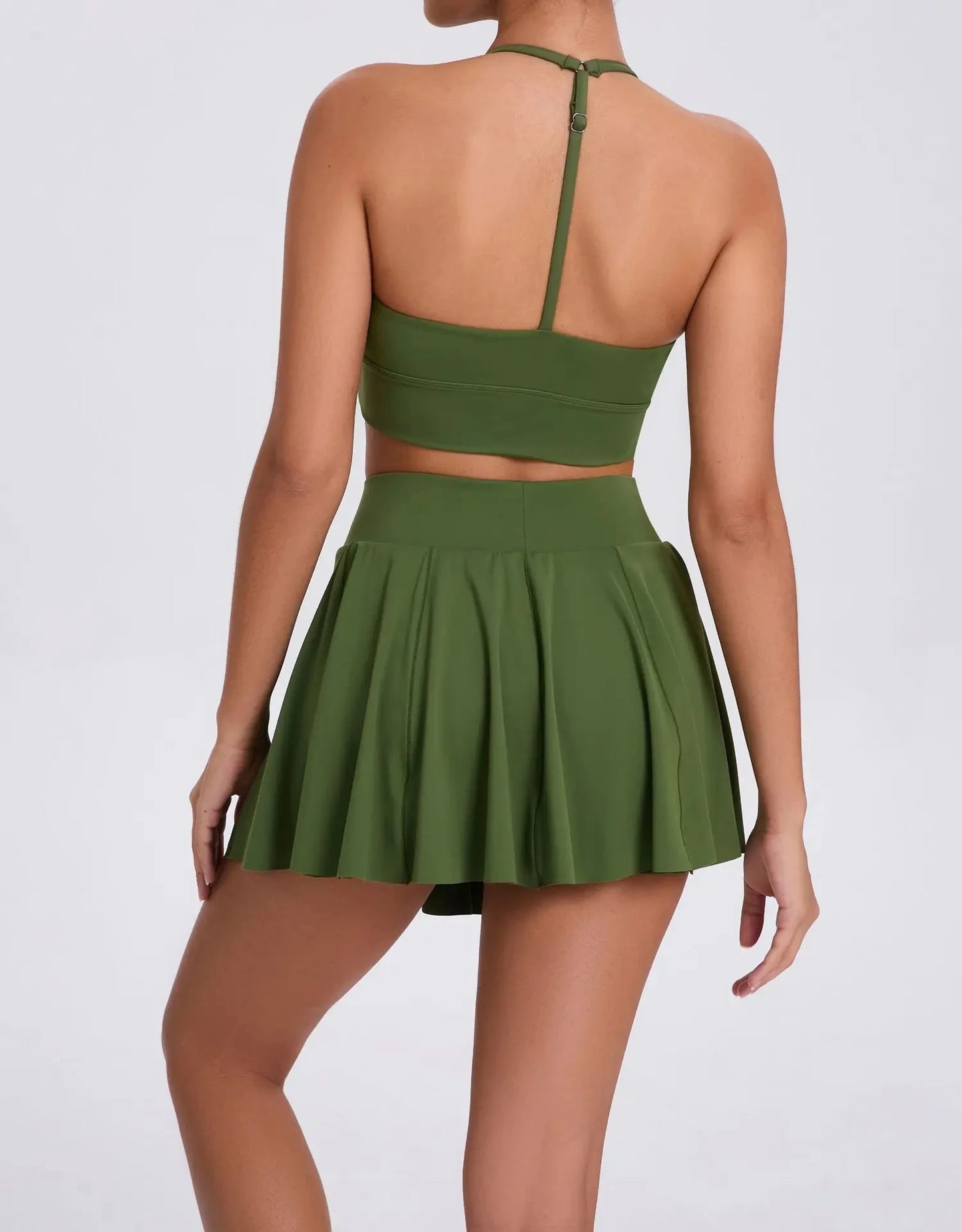Green two-piece outfit with a crop top and skirt on a white background