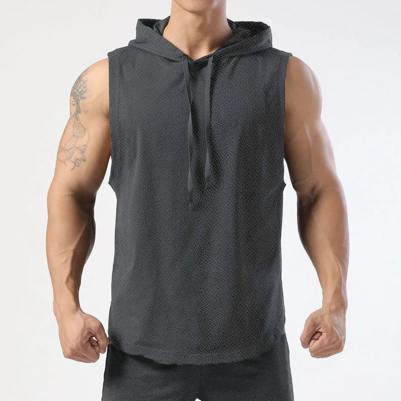 Person wearing a dark gray sleeveless hoodie on a light gray background