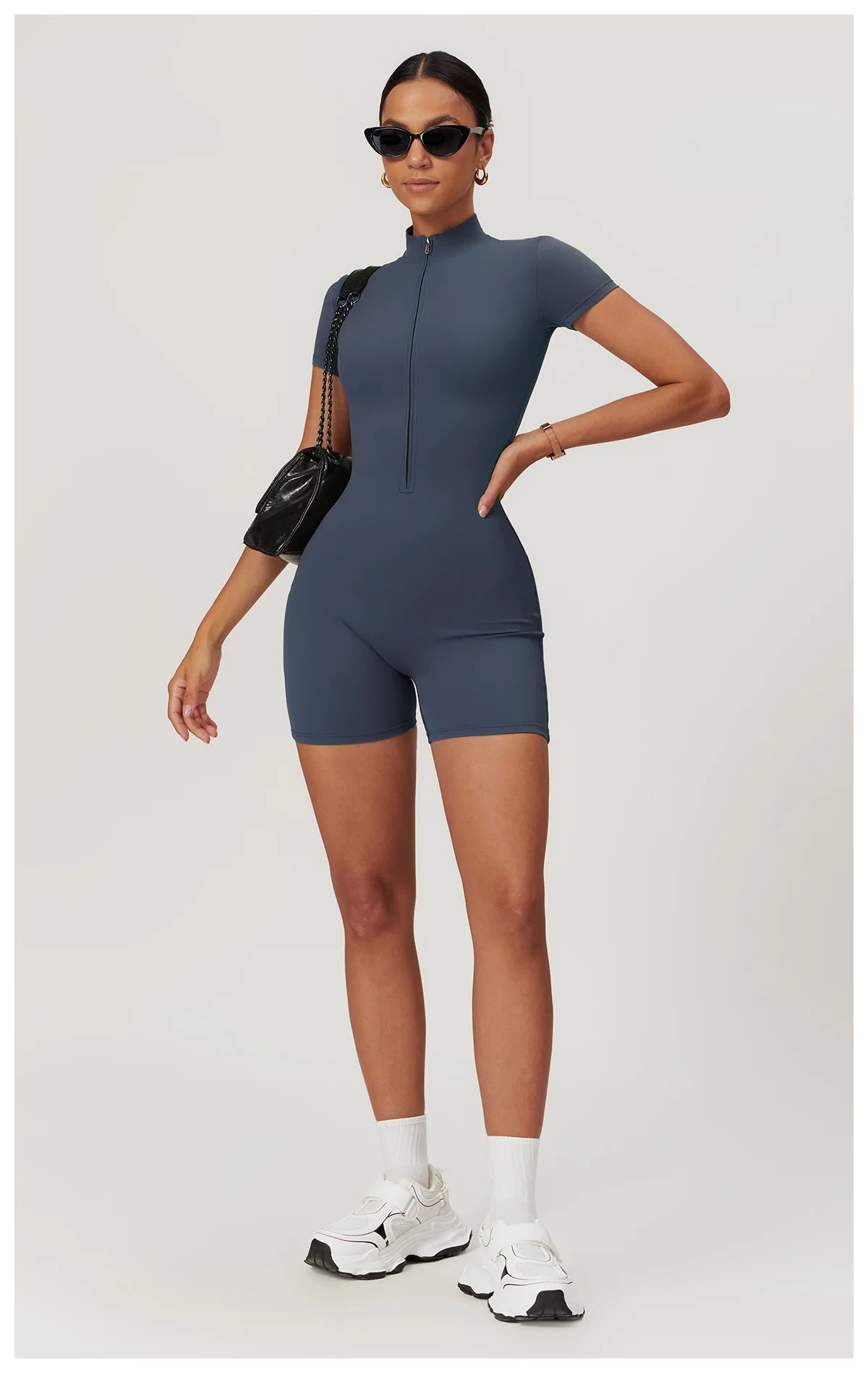 Woman wearing a blue romper on a white background