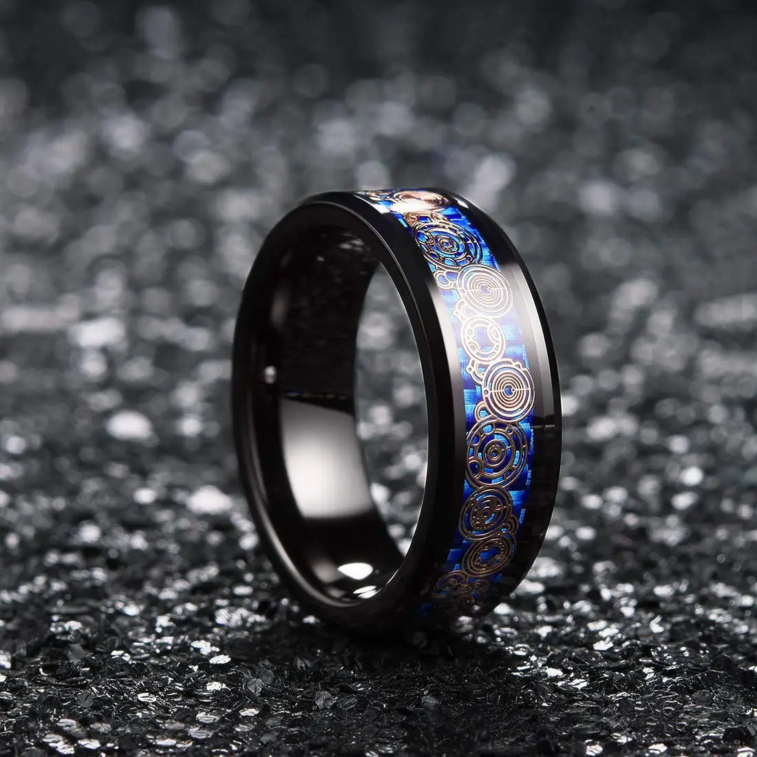 Black ring with blue and gold interior design on a dark textured background