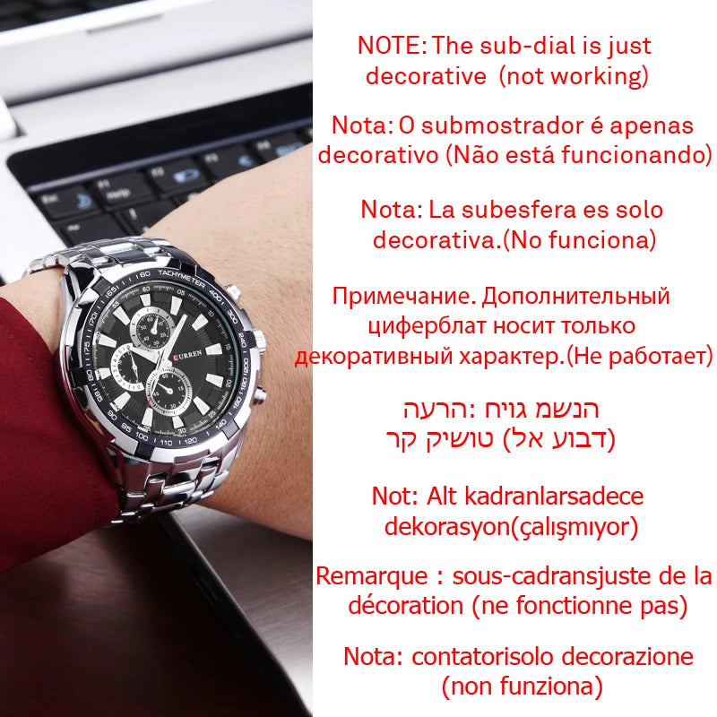 Wrist wearing a watch with decorative sub-dial, laptop in background
