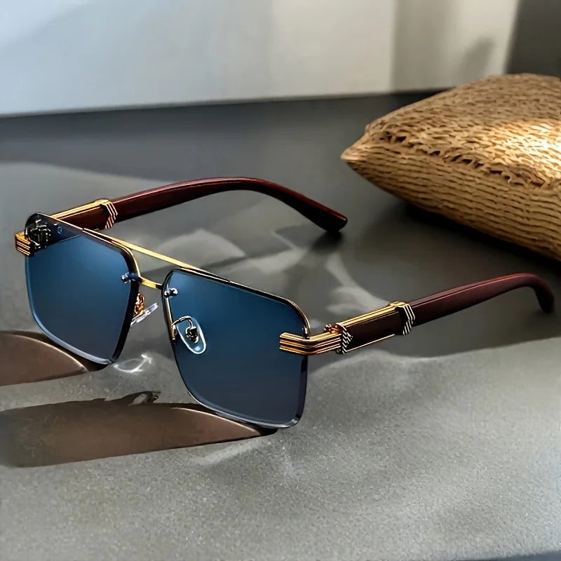 Sunglasses with gold and brown frame on a reflective surface