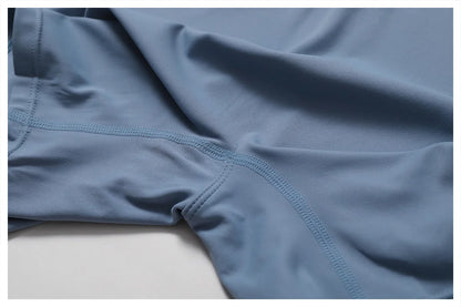 Close-up of blue athletic shorts on a light gray background