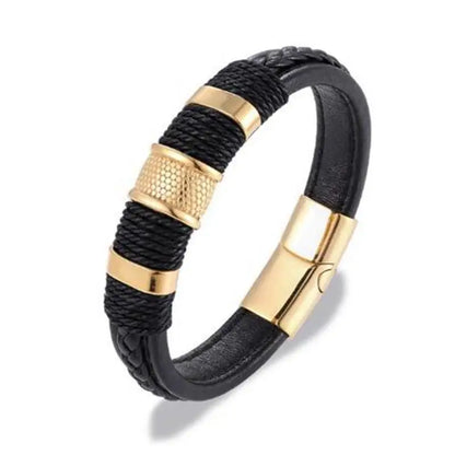 Black leather bracelet with gold accents on a white background
