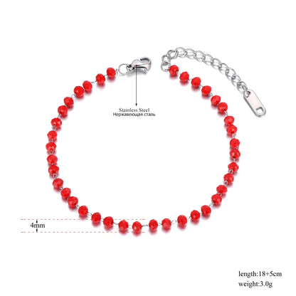 Red beaded bracelet with silver clasp on a white background