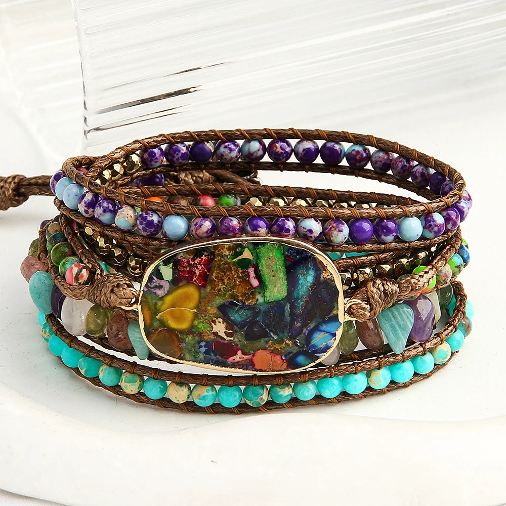 Multicolored beaded wrap bracelet with a central focal bead on a white background