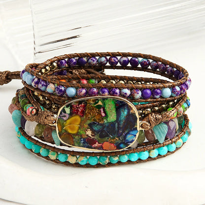 Multicolored beaded wrap bracelet with a central focal bead on a white background