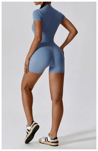 Person wearing a blue bodysuit on a light gray background