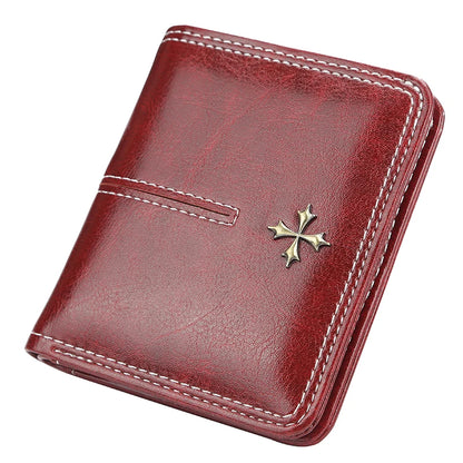 Red leather wallet with a gold cross emblem on a white background