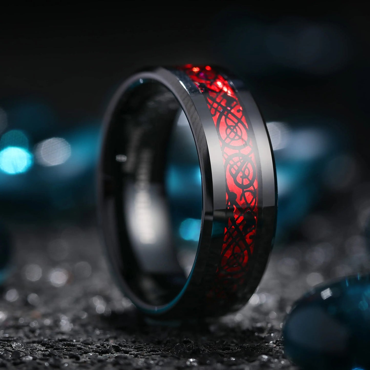 Black ring with red engraving on a dark background