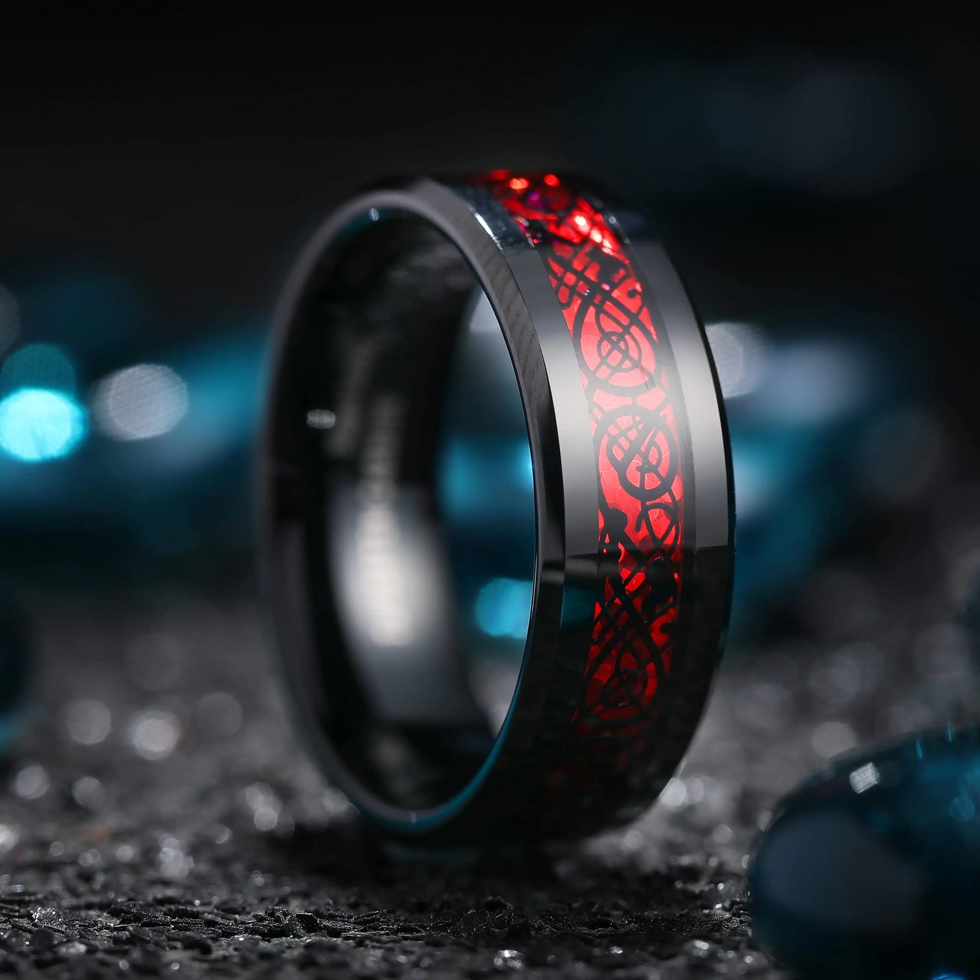Black ring with red engraving on a dark background