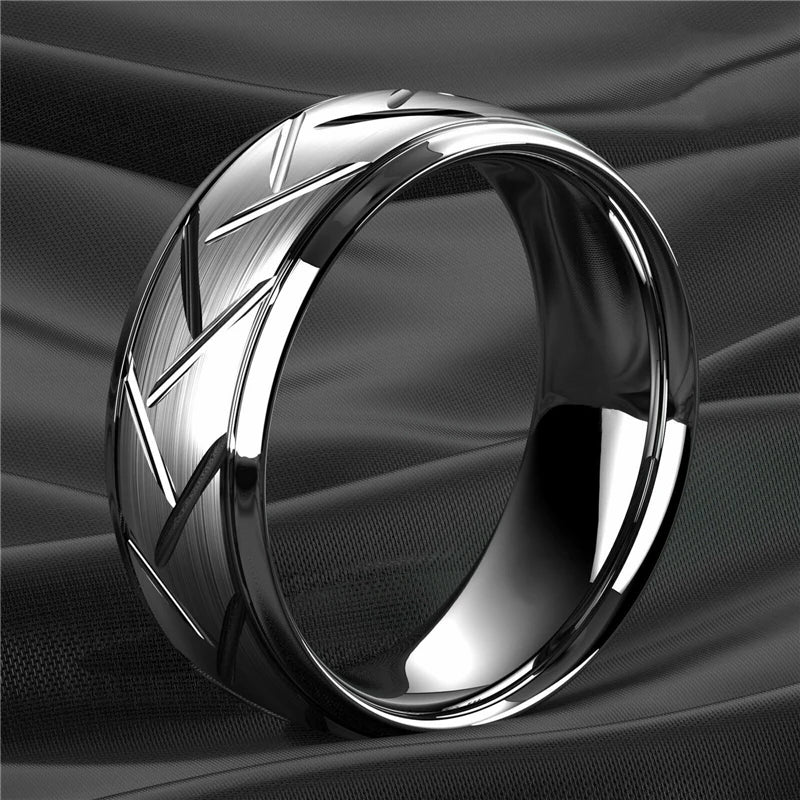 Silver ring with geometric design on a black fabric background