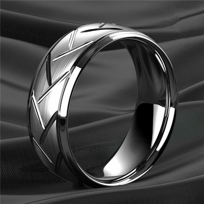Silver ring with geometric design on a black fabric background
