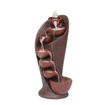 Decorative water fountain with brown and terracotta colors on a white background