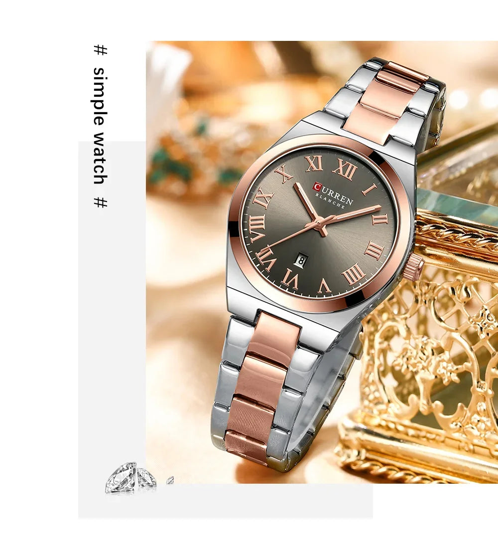 Silver and rose gold watch with a decorative box on a light background