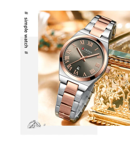 Silver and rose gold watch with a decorative box on a light background